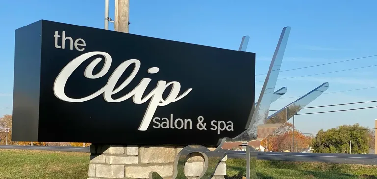 A photo of a monument sign for Clip Salon and Spa.